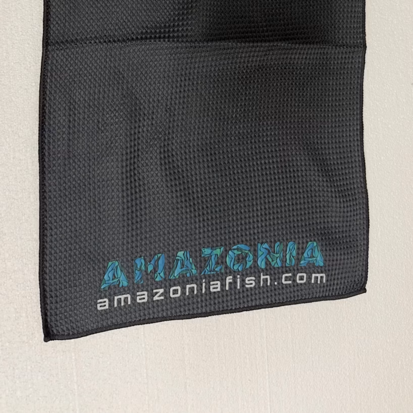 Black Amazonia waffle towel with the fish-pattern logo and amazoniafish.com