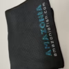Folded black Amazonia towels with the logo along the edge